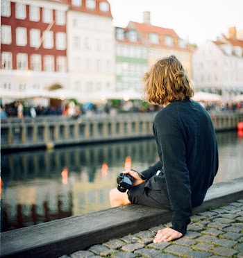 Person Siting Near River