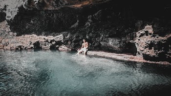 Person Sitting Beside a Body of Water
