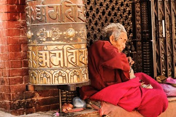 Person Sitting Beside Black Metal Gate