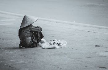 person sitting beside street