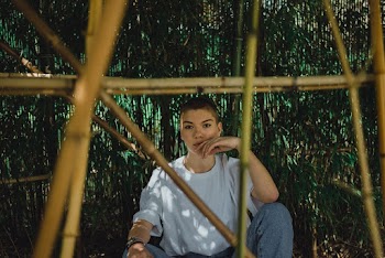 Person Sitting Beside Tree