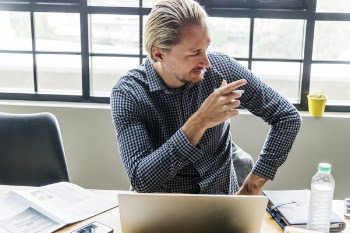 Person Sitting in Front of Laptop Computer