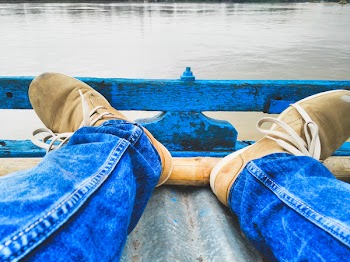 Person Sitting Near Body of Water