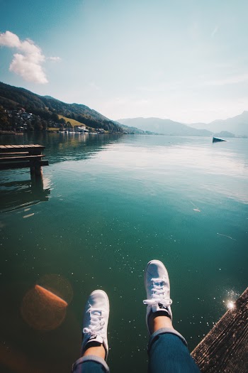 Person Sitting Near Body of Water