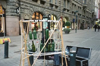 Person Sitting Near Hanging Bottles and Opened Box