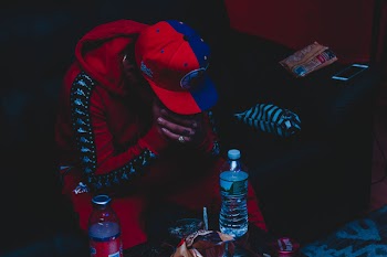 Person Sitting Near Plastic Bottle