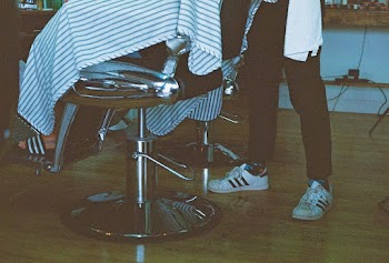 Person Sitting on Barber's Chair