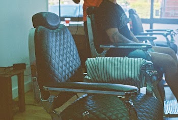 Person Sitting on Barber Chair