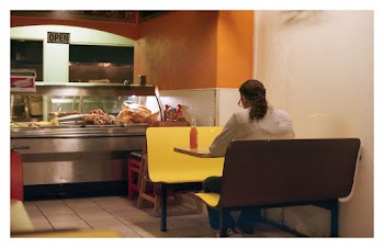 Person Sitting on Bench  Inside a Restaurant 