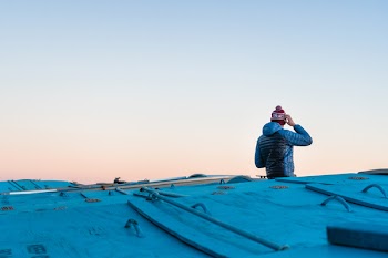 Person Sitting on Blue Cover