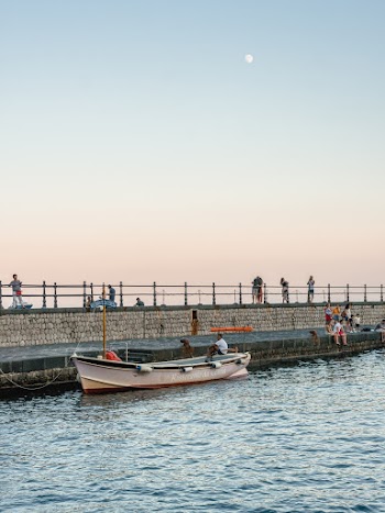 Person Sitting on Boat Beside Dock