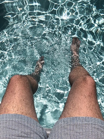 Person Sitting on Body of Water