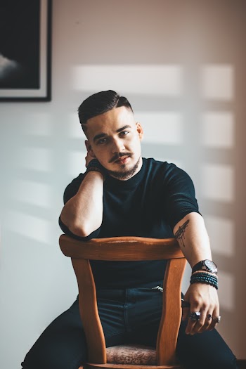 Person Sitting On Brown Chair Indoors