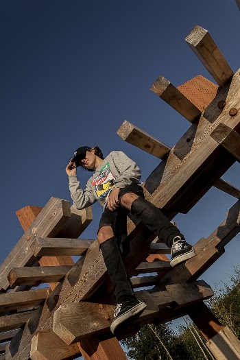 Person Sitting on Brown Wooden Outdoor Playset