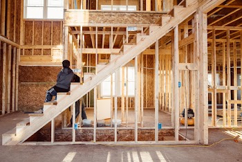 Person Sitting On Brown Wooden Stairs