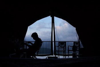 person sitting on chair inside canopy tent