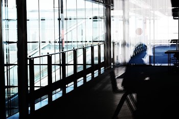 person sitting on chair near balustrade