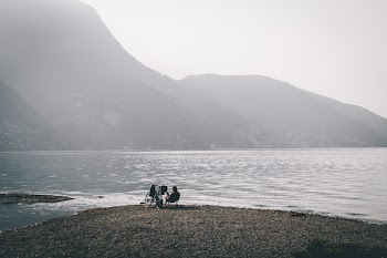 Person Sitting on Chair on Seashore