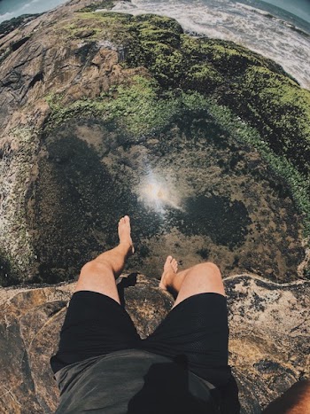 Person Sitting on Cliff