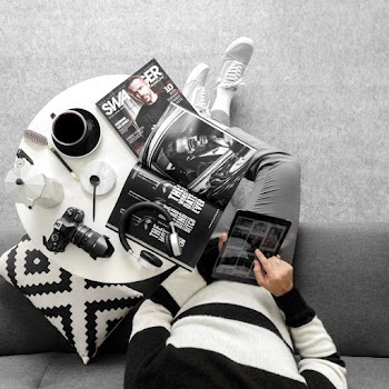 Person Sitting On Grey Couch Using Ipad