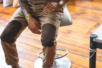 Person Sitting On Grey Swivel Barstool