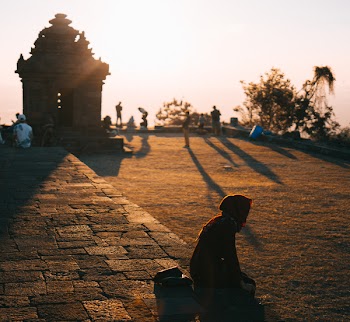 Person Sitting on Ground Outdoors