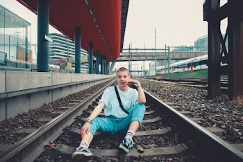 Person Sitting on Railway