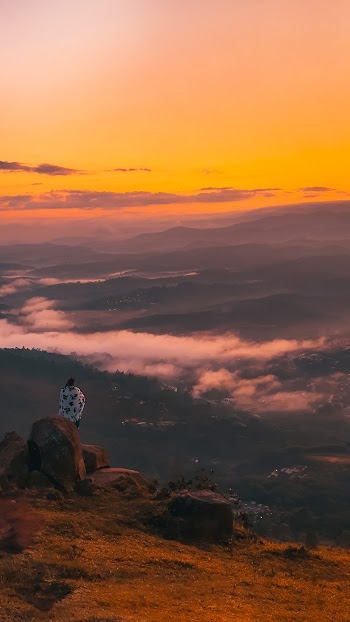 Person Sitting on Rock