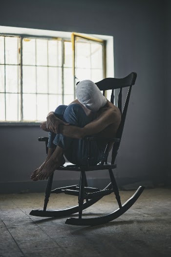 Person Sitting on Rocking Chair Inside Room