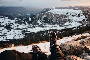 Person Sitting on Sea Cliff