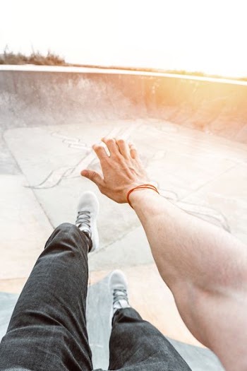 person sitting on skateboard ramp