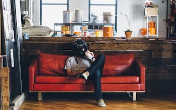 person sitting on sofa with helmet