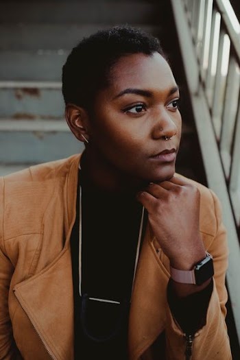 person sitting on stairs during daytime