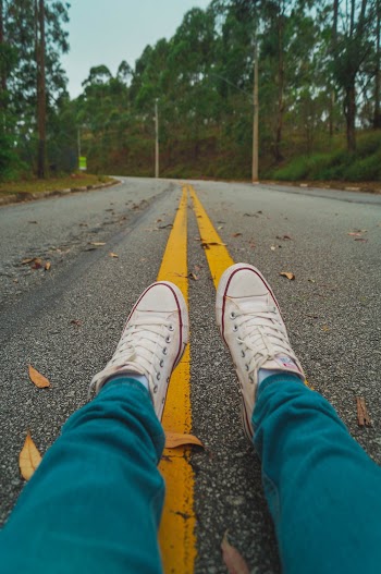 Person Sitting on the Middle Of The Road