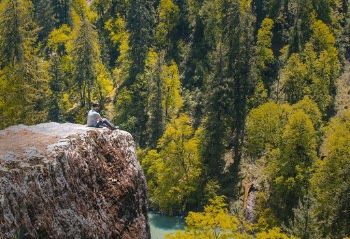 Person Sitting on the Stone
