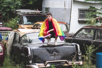 Person Sitting on Vehicle Hood