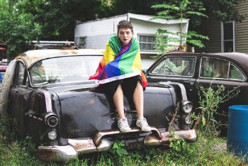 Person Sitting on Vintage Black Car