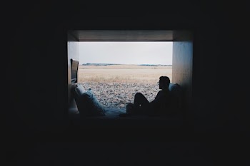 person sitting while looking outside