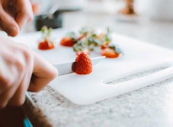 Person Slicing A Strawberry