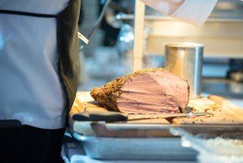 Person Slicing Cooked Meat