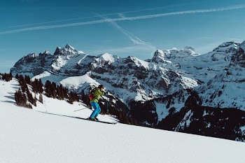 person snow skiing near snow capped mountain
