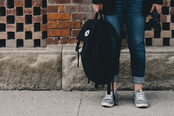 Person Standing and Carrying Bag