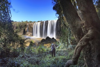 Person Standing and Looking Towards Water Falls
