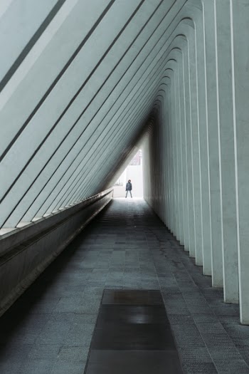 Person Standing at the End of a Hallway