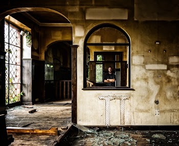 Person Standing Behind Black Wooden Window