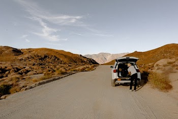 Person Standing Behind Vehicle