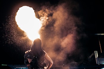 Person Standing Beside Fire during Night Time