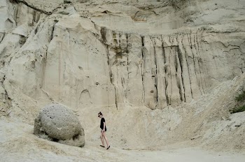 person standing beside stone
