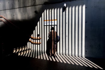 Person Standing Beside Wall