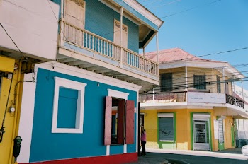 Person Standing Between Houses